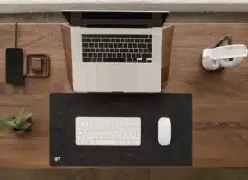 a laptop computer sitting on top of a wooden desk