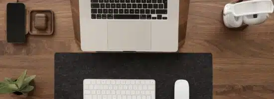 a laptop computer sitting on top of a wooden desk