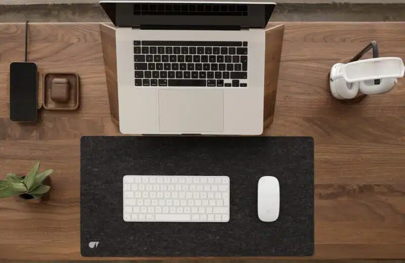 a laptop computer sitting on top of a wooden desk