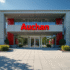 Entrée d'un immeuble moderne avec logo Auchan en évidence